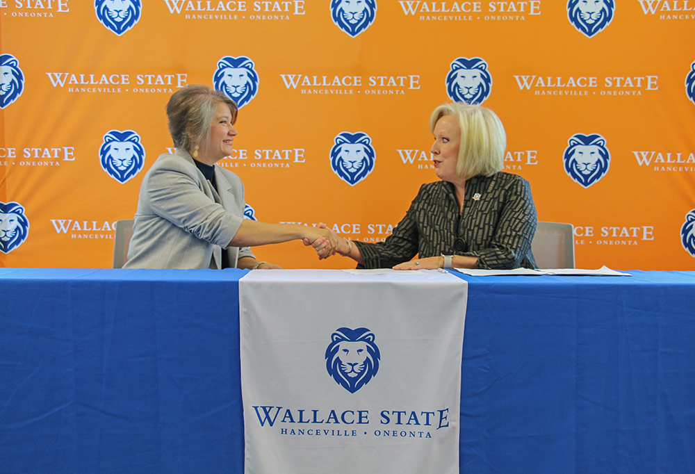 Tracy Rushing of R.E. Garrison Trucking shakes hands with Wallace State President Dr. Vicki Karolewics after signing the Powerful Partnerships Agreement. Tracy Rushing of R.E. Garrison Trucking shakes hands with Wallace State President Dr. Vicki Karolewics after signing the Powerful Partnerships Agreement.